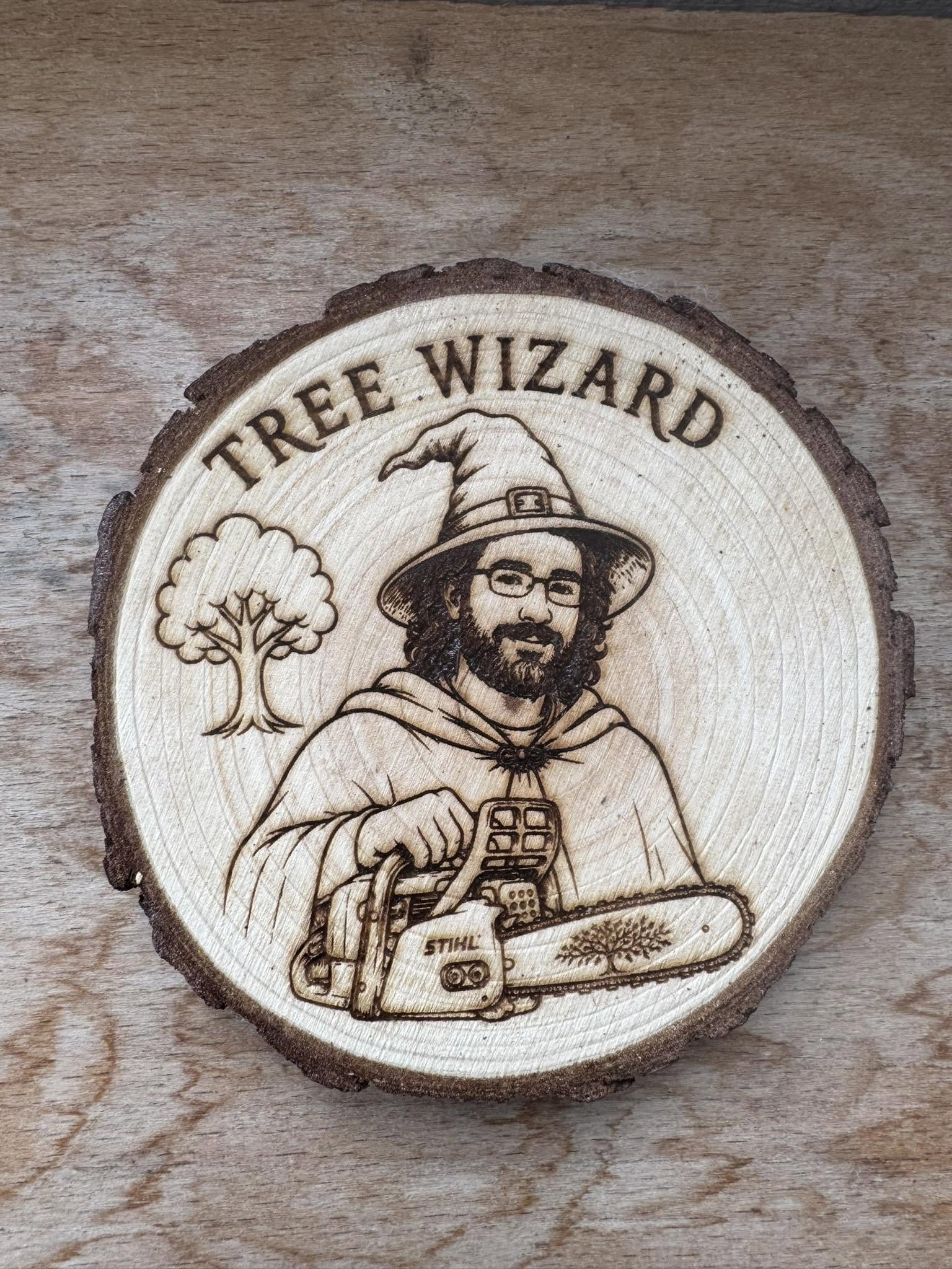 A hand-burnt wooden plaque of the Tree Wizard holding a chainsaw beside a tree